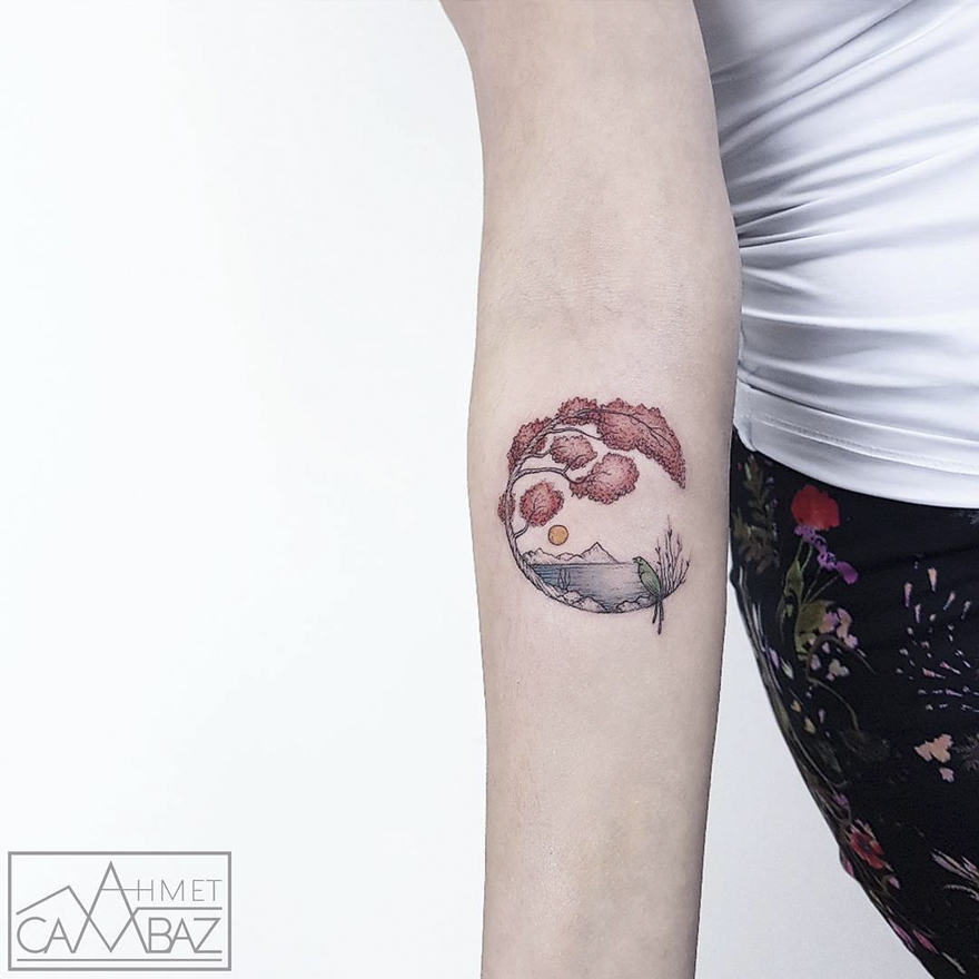 Simple yet striking tattoo by Turkish cartoonist on arm, featuring nature-inspired design with mountains and trees.