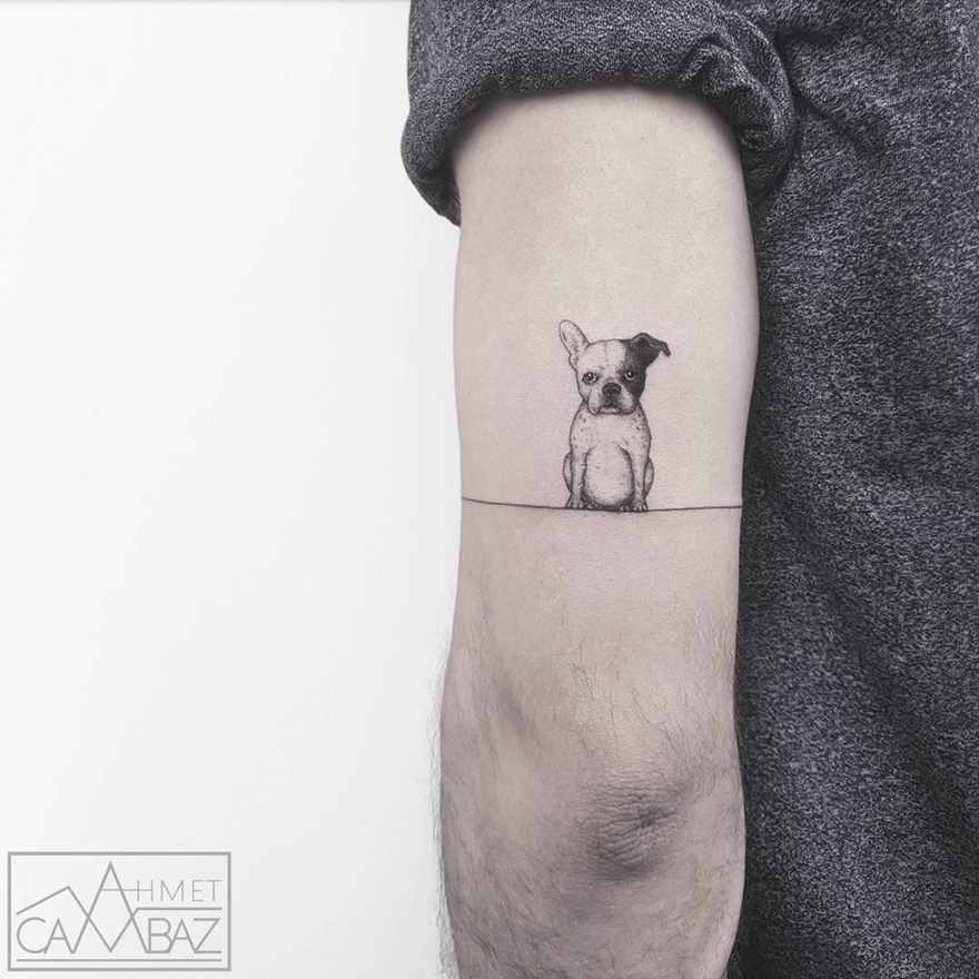 Simple tattoo of a small dog on an arm by Turkish cartoonist.
