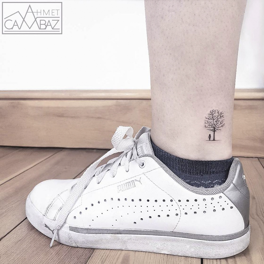 Minimalist tree tattoo on ankle next to white sneaker, by Turkish cartoonist-turned-artist.