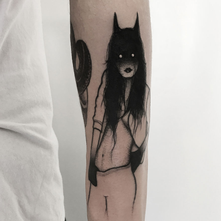 Faceless girl tattoo with dark hair and eerie expression on forearm, featuring a mysterious, slightly erotic design.