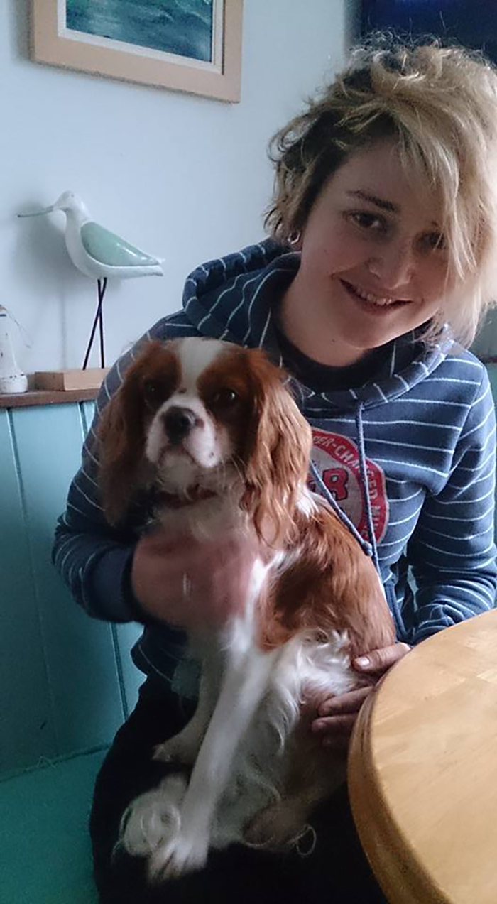 Person smiling with a dog, illustrating that depression symptoms have no face.