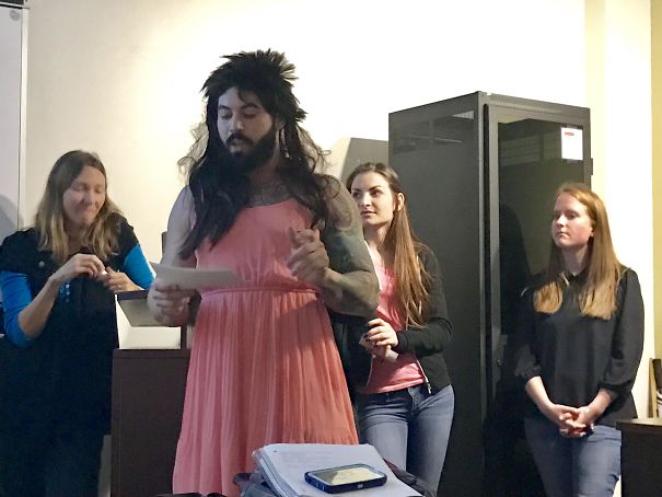 Funny presentation on feminism and person wearing dress and wig