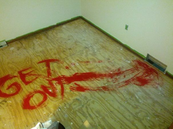 "get out" painted with red paint on the floor 