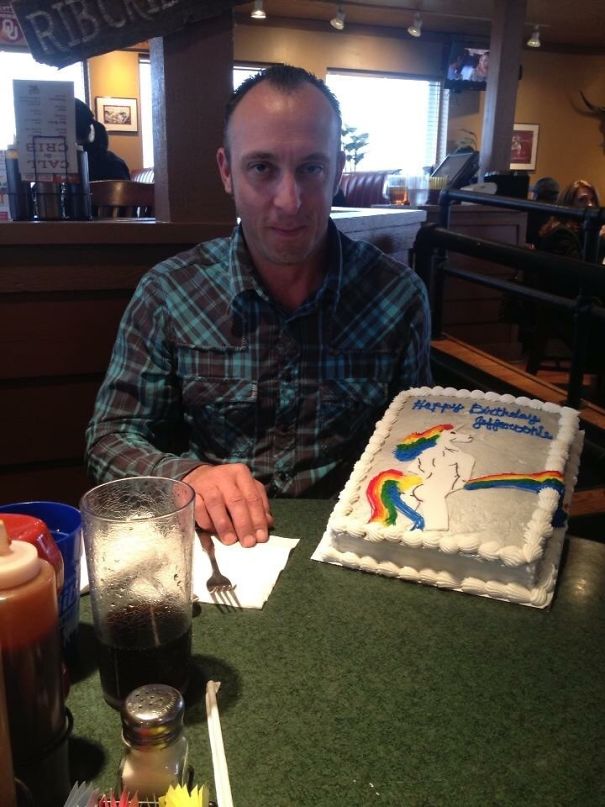 man holding a cake with unicorn 