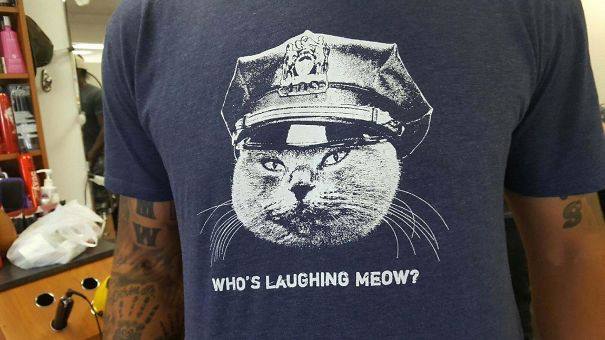 a t-shirt with cat wearing a police hat 