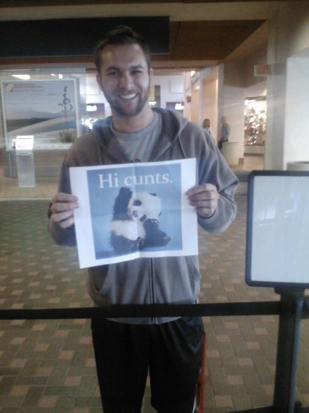Man holding a funny airport pickup sign with a panda image and humorous text, making everyone chuckle.