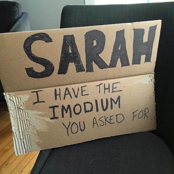 Funny airport pickup sign on cardboard for Sarah mentioning Imodium request.