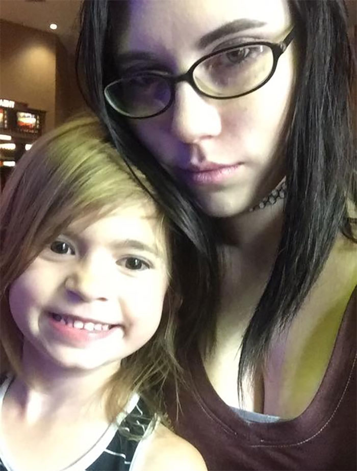 Woman with glasses and child smiling, illustrating that depression symptoms have no face.