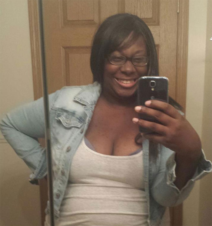 Smiling person in denim jacket taking a selfie, illustrating that depression symptoms have no face.