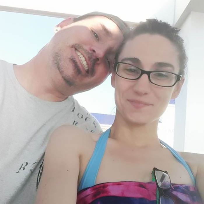 A smiling couple poses for a selfie, illustrating how depression symptoms have no face.