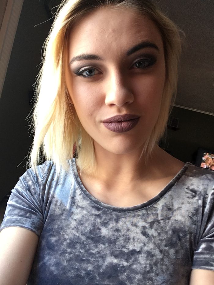 Blonde person with makeup, wearing a gray top, highlighting the concept that depression symptoms have no face.