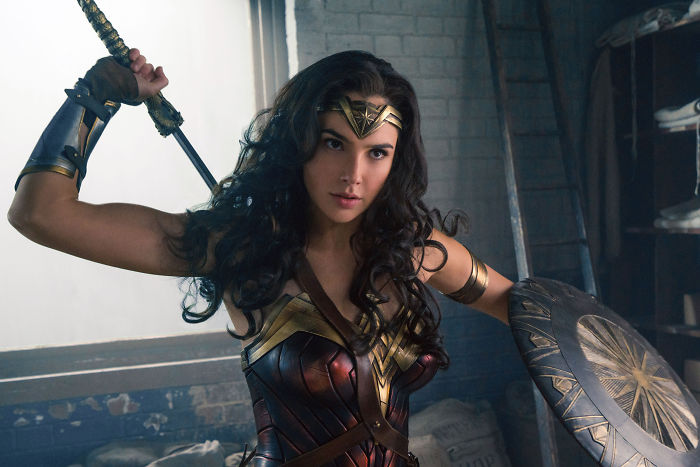 Wonder Woman in action holding sword and shield ready for battle in a dynamic movie scene full of fun movie facts.