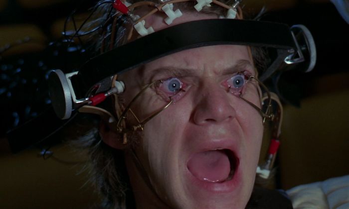 Scene from A Clockwork Orange movie showing a man with eyes forced open in a disturbing movie moment, highlighting fun facts about movies.