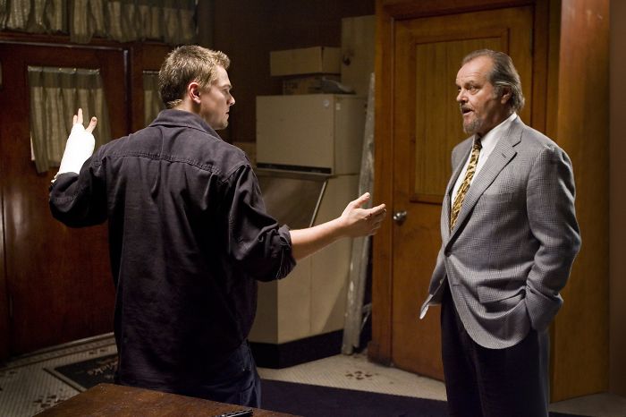 Scene from The Departed movie showing two men engaged in a tense conversation about crime and loyalty.