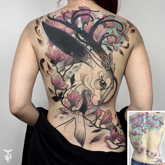 Nature and Art Nouveau inspired tattoo with floral and bird motifs on a person's back.