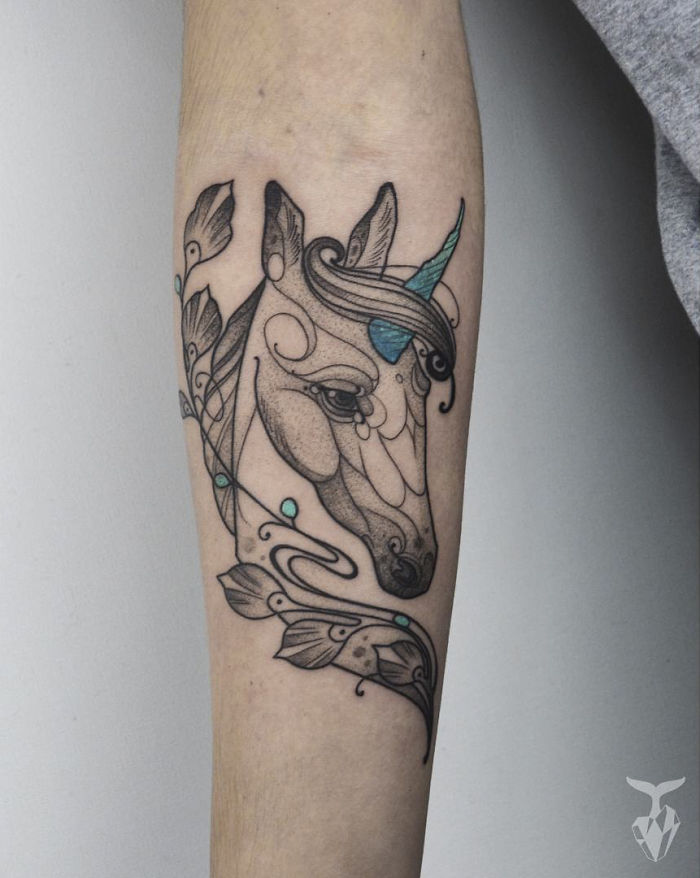 Nature and Art Nouveau-inspired tattoo of a horse with ornate detailing on forearm.