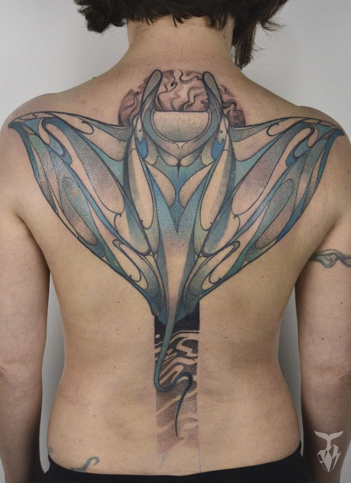 Back tattoo inspired by nature and Art Nouveau, featuring intricate, flowing lines and organic shapes.