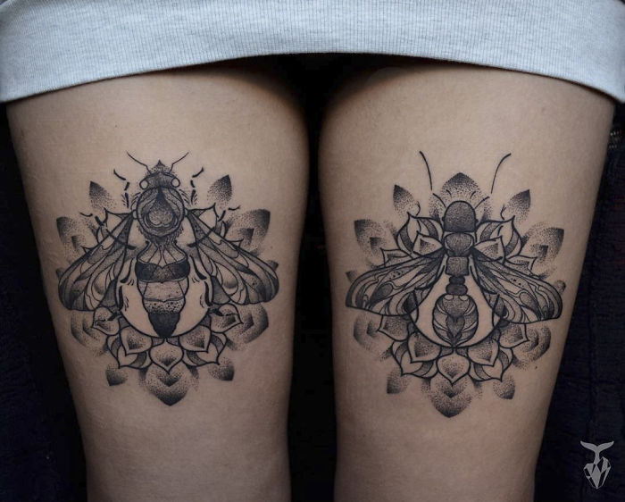 Nature and Art Nouveau inspired tattoos of bees with floral patterns on both thighs.