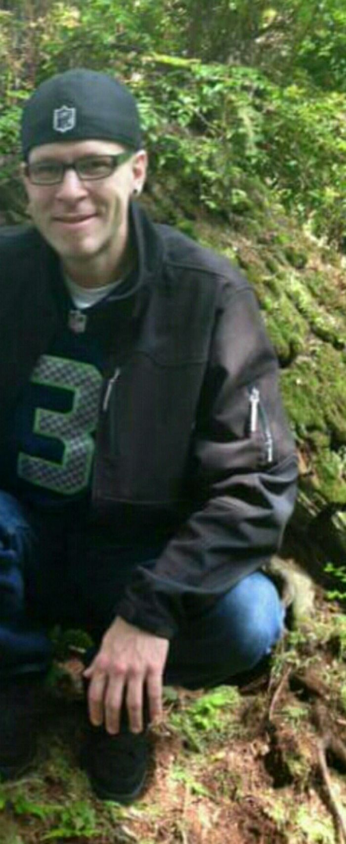 Person outdoors wearing a black jacket and cap, exemplifying how depression symptoms have no face.