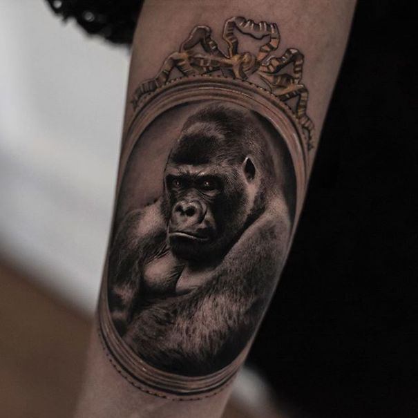 Realistic gorilla tattoo by Belgian artist, with lifelike detail giving a printed-on-skin appearance.