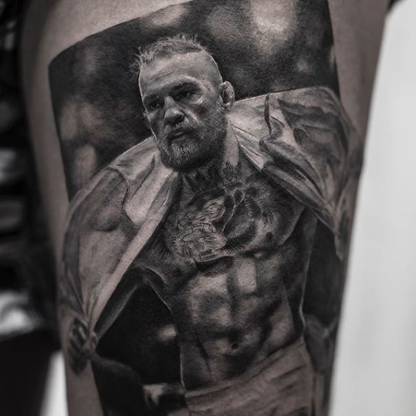 Realistic tattoo of a muscular man on skin by Belgian tattooist, appearing printed.