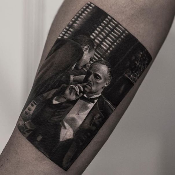 Realistic tattoo of a classic movie scene on arm, showcasing detailed artistry by Belgian tattooist.