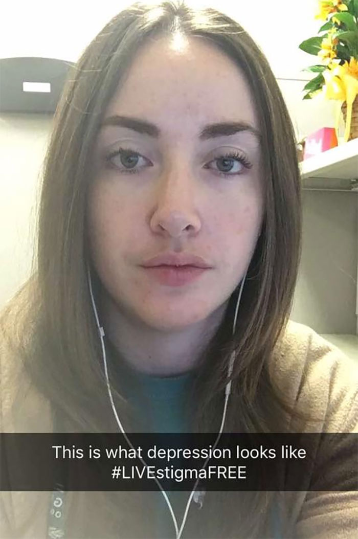 Woman in office setting, staring directly ahead, illustrating that depression symptoms have no face, with the hashtag #LIVEstigmaFREE.