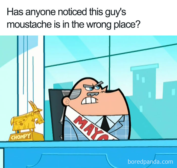 Cartoon logic showcased as a mayor with a misplaced mustache sits at a desk with a gold trophy labeled "Chompy."