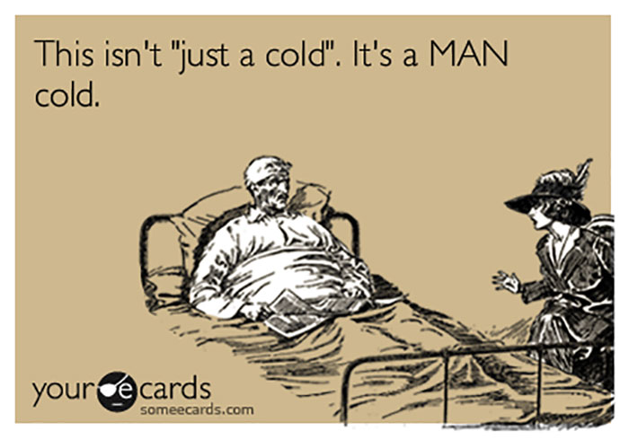 Cartoon of a husband in bed, claiming it's a "man cold," humorously exaggerating his illness.