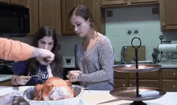 a gif of person pulling out a poultry from the cooked turkey 
