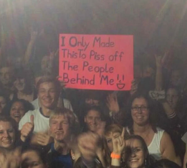 man made a huge sign to annoy people behind him 