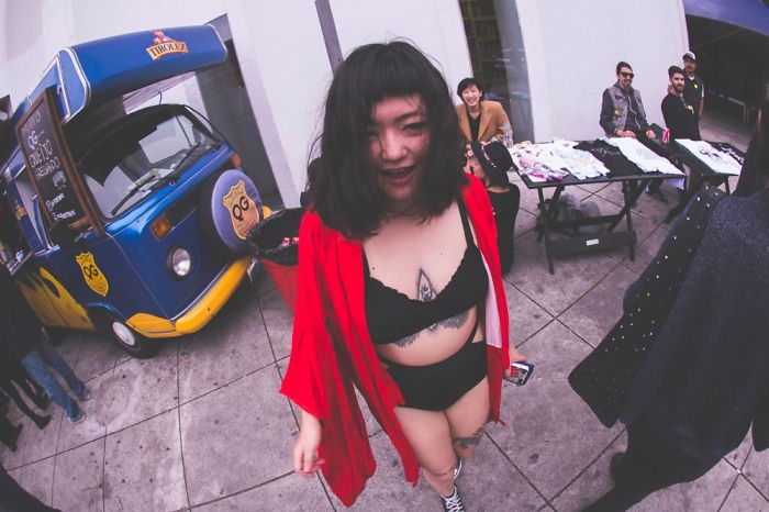 Person smiling in a unique outfit at an outdoor market, highlighting that depression symptoms have no single face.