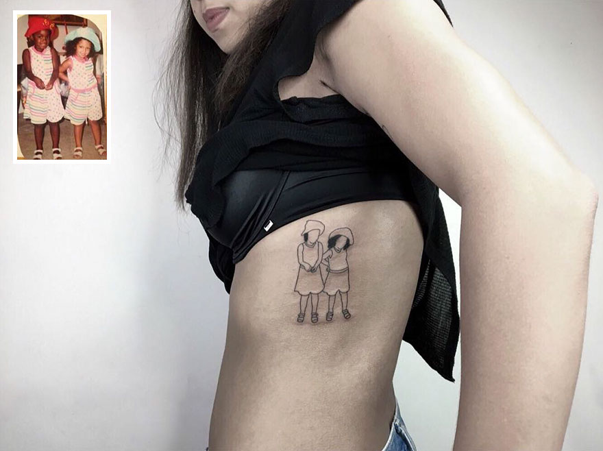 Tattoo of nostalgic childhood photo on woman's side, featuring two children holding hands in hats and dresses.