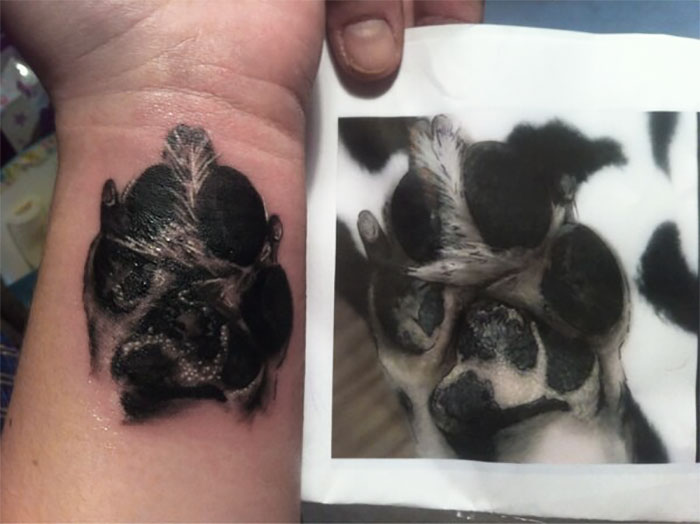 Dog paw print tattoo on wrist next to a photo of the original paw, showcasing creative tattoo design.