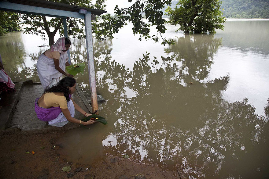 Villagers Offer Prayers For The Floodwaters To Recede, In Chandrapur Village, East Of Gauhati, Assam