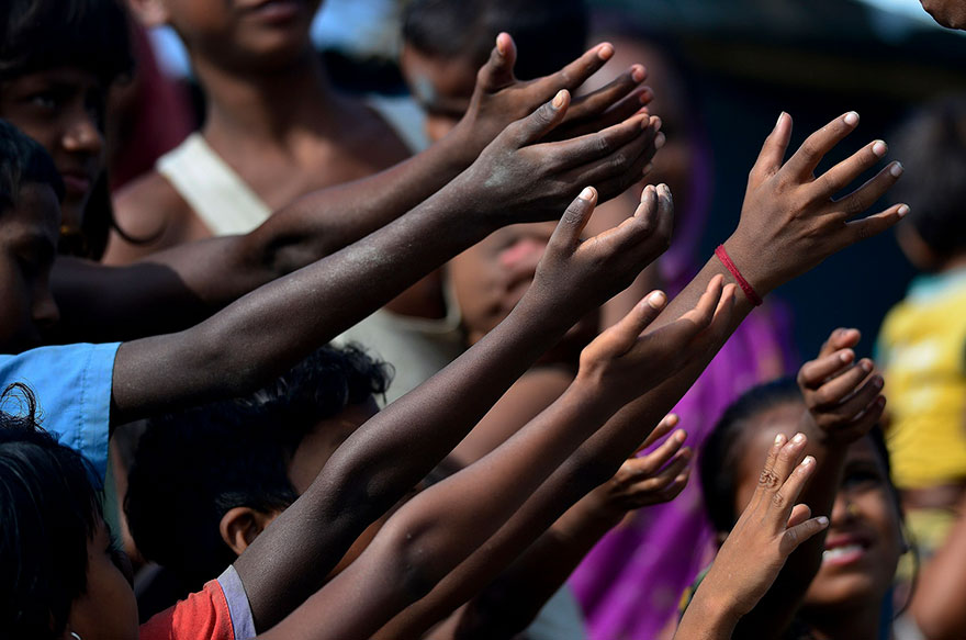 Children Raise Their Hand For Biscuit Packets, Being Distributed By Volunteers At A Hastily Constructed Camp In Assam State Where More Than A Million People Have Lost Their Homes