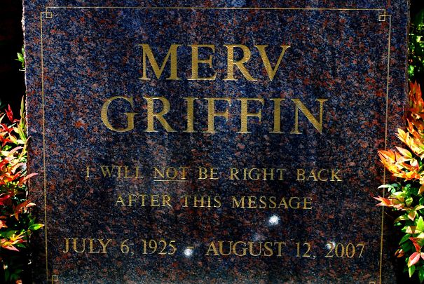 Tombstone with a humorous epitaph by Merv Griffin reading I will not be right back after this message in gold letters.