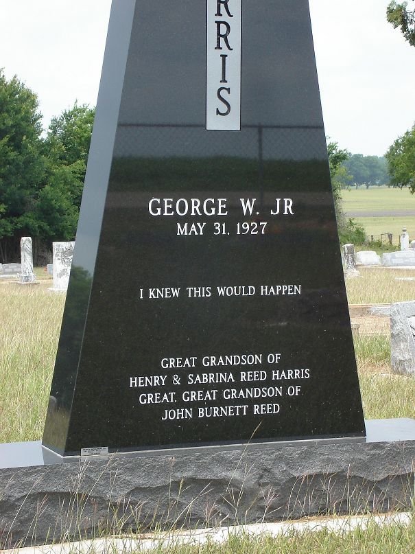 Black tombstone with humorous inscription I knew this would happen, located in a grassy cemetery with other tombstones visible.