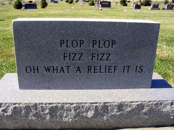 Funny tombstone in a cemetery with an undying humor inscription saying plop plop fizz fizz what a relief it is