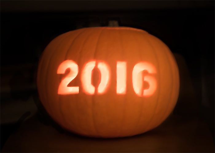 Carved pumpkin with "2016" glowing in the dark. Scary pumpkin design idea.