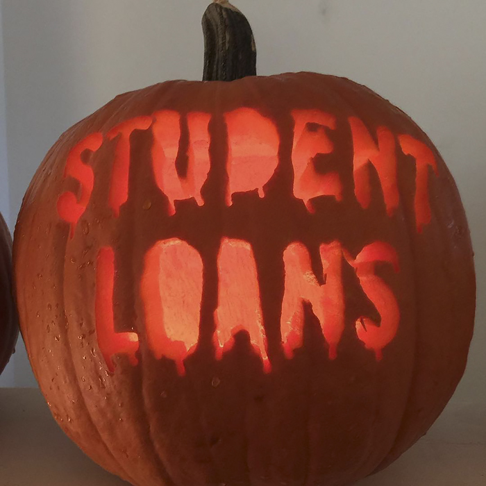 Scary carved pumpkin with "STUDENT LOANS" in eerie letters.
