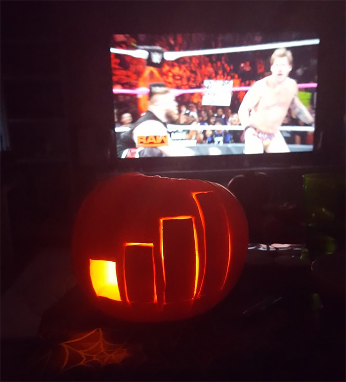 Scariest pumpkin carving with a TV wrestling match in the background.