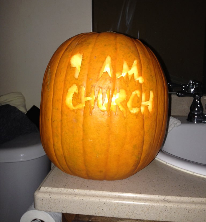 Scary carved pumpkin with "9 a.m. church" message on bathroom counter.