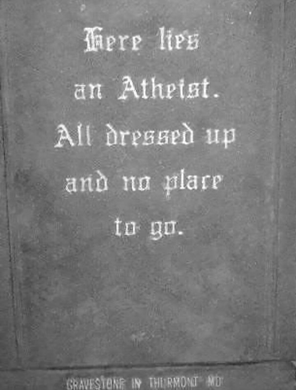 Funny tombstone inscription reading there lies an atheist all dressed up and no place to go on gray stone.
