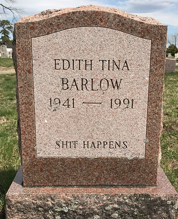 Funny tombstone with the inscription S**t Happens on Edith Tina Barlow's grave in a grassy cemetery setting.