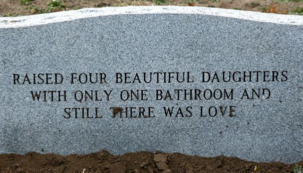 Gray tombstone with a humorous epitaph about raising four daughters with one bathroom, showcasing funny tombstones.