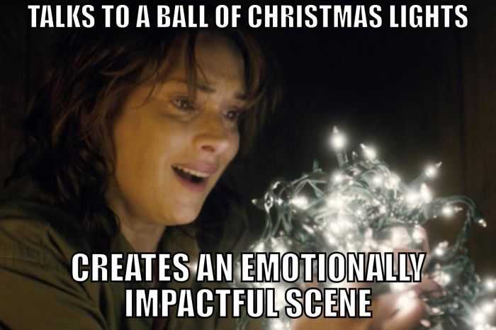 A woman from Stranger Things holds Christmas lights, creating an evocative scene.