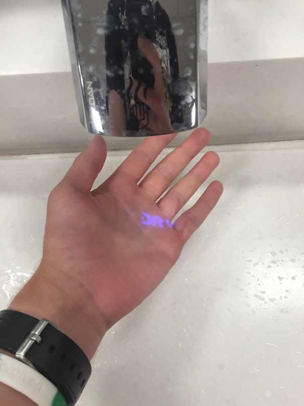 This Hand Drier At The Airport Projecting The Word "Dry"
