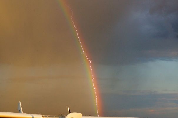 Lightning Strikes A Plane As It Flies Through A Rainbow