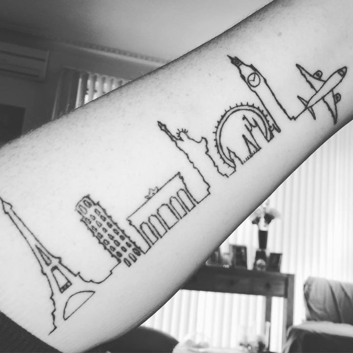 Travel tattoo featuring iconic landmarks like the Eiffel Tower and Big Ben in minimalist line art on an arm.